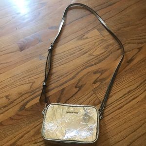 A silver crossbody Michael kors purse
